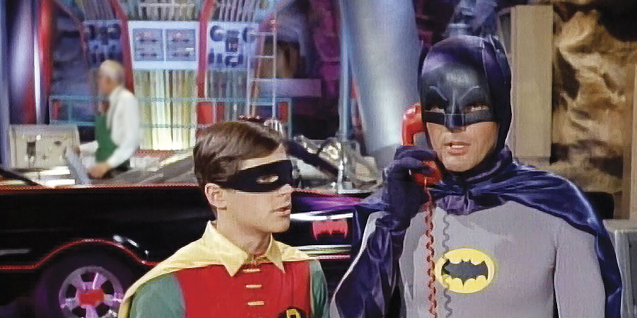 Batman and Robin are struggling to hear Commissioner Gordon over their VoIP-reliant Batphone. (image property of Warner Bros.)